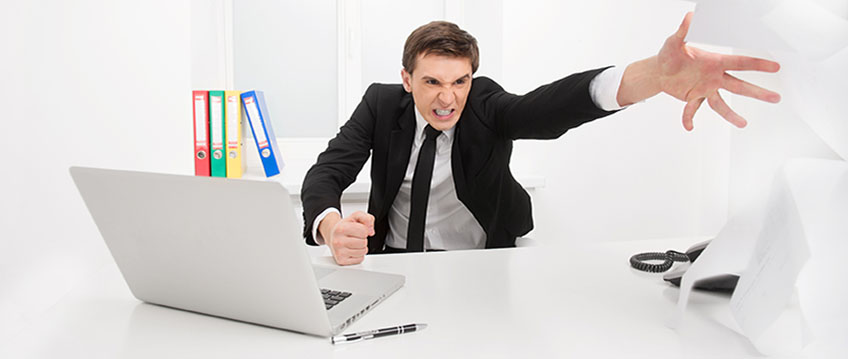image of man throwing papers across desk